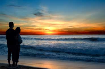 Couple on the Beach Watching a Hawaiian Sunset