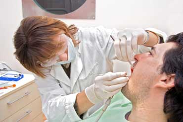 Dentist Examining Patient's Teeth