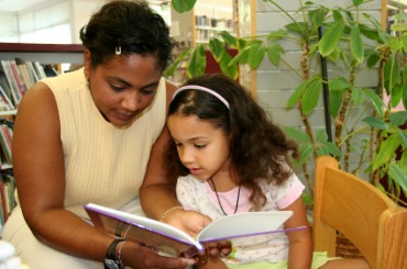 Mother Reading a Book to Her Daughter