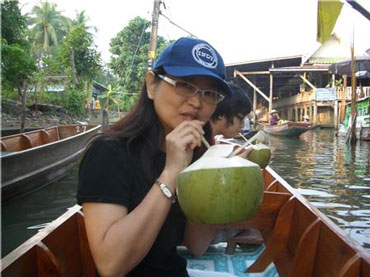 Woman Drinking Coconut Juice with a Straw
