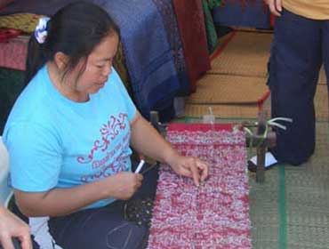 Woman Weaving a Pattern onto Silk